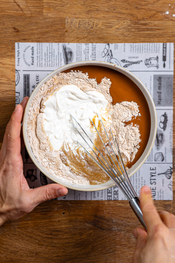 alle zutaten fuer glutenfreier apfelkuchen in einer schuessel werden mit schneebesen vermengt