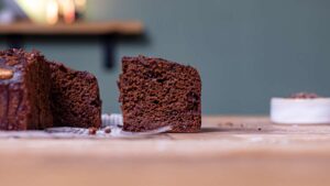 ein stueck brownie fuer gesundes schnelles fruehstueck von vorne auf einem holztisch